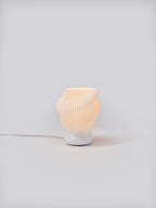 White Dollop Lamp illuminated on a white studio background, showing pleated shade and soft glow