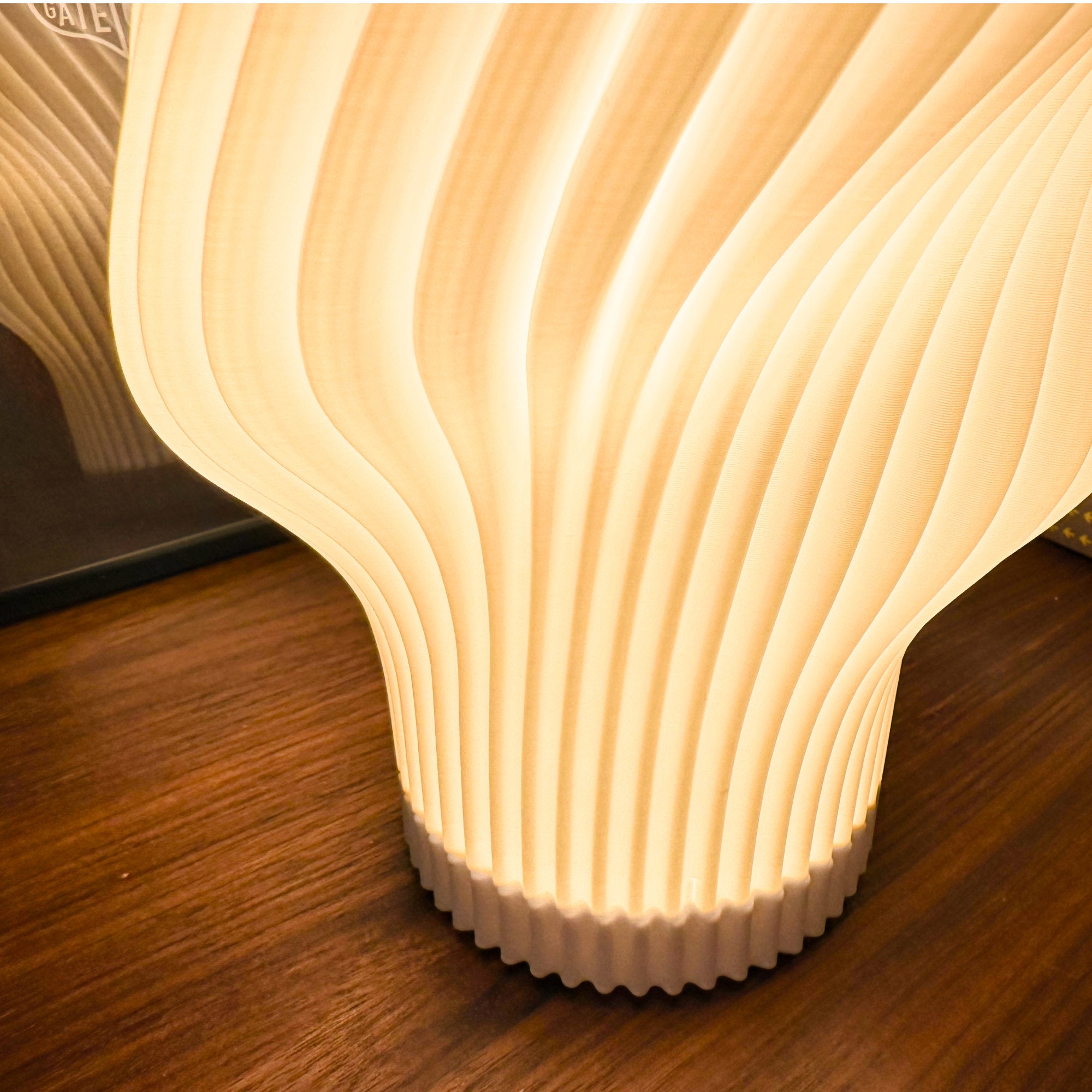 Flourish lamp illuminated close-up showing the pleated shade