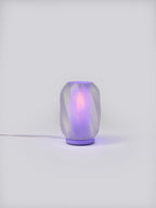 Lavender Nixie Lamp illuminated on a white studio background, showing colorful glow