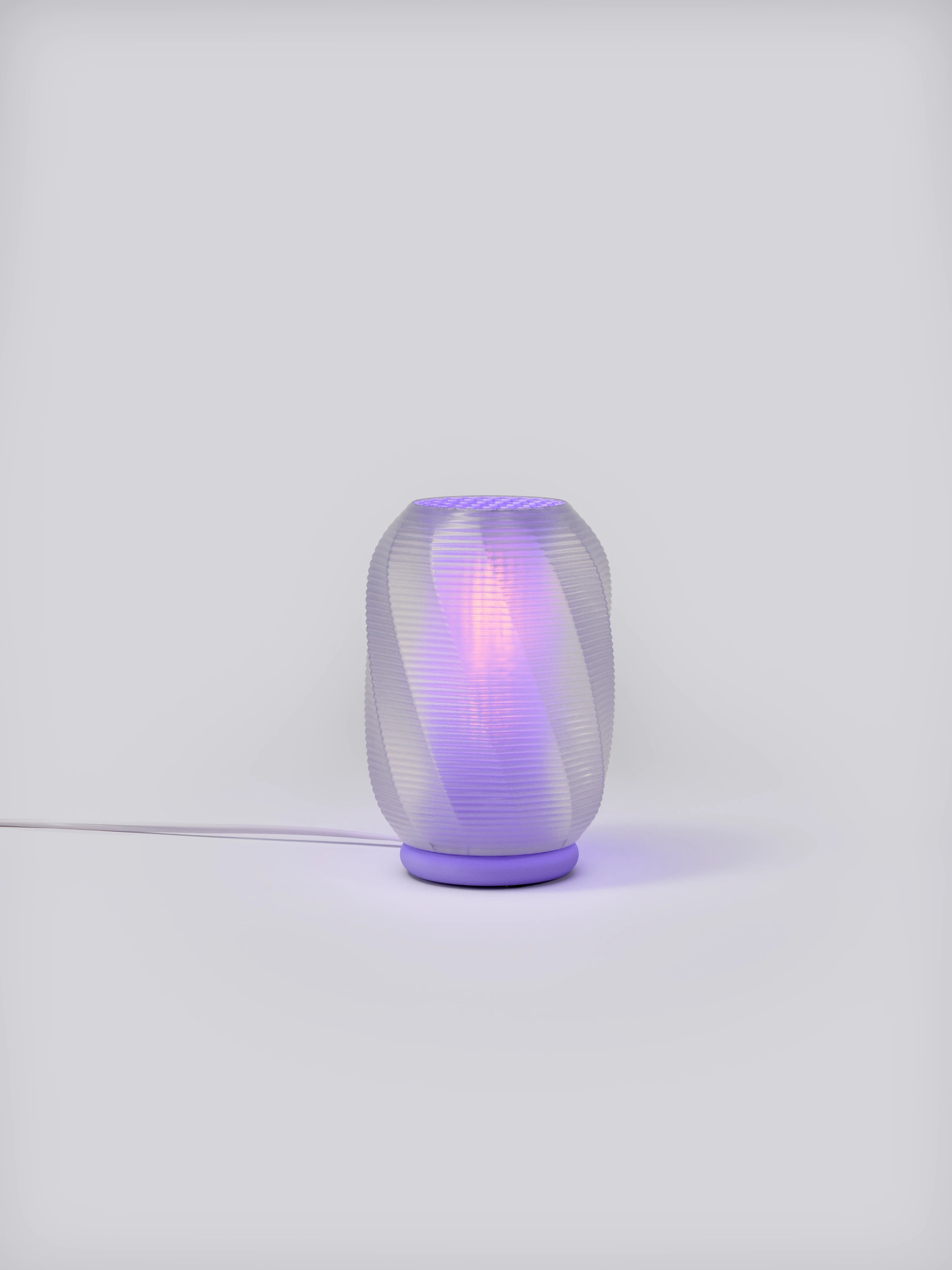 Lavender Nixie Lamp illuminated on a white studio background, showing colorful glow