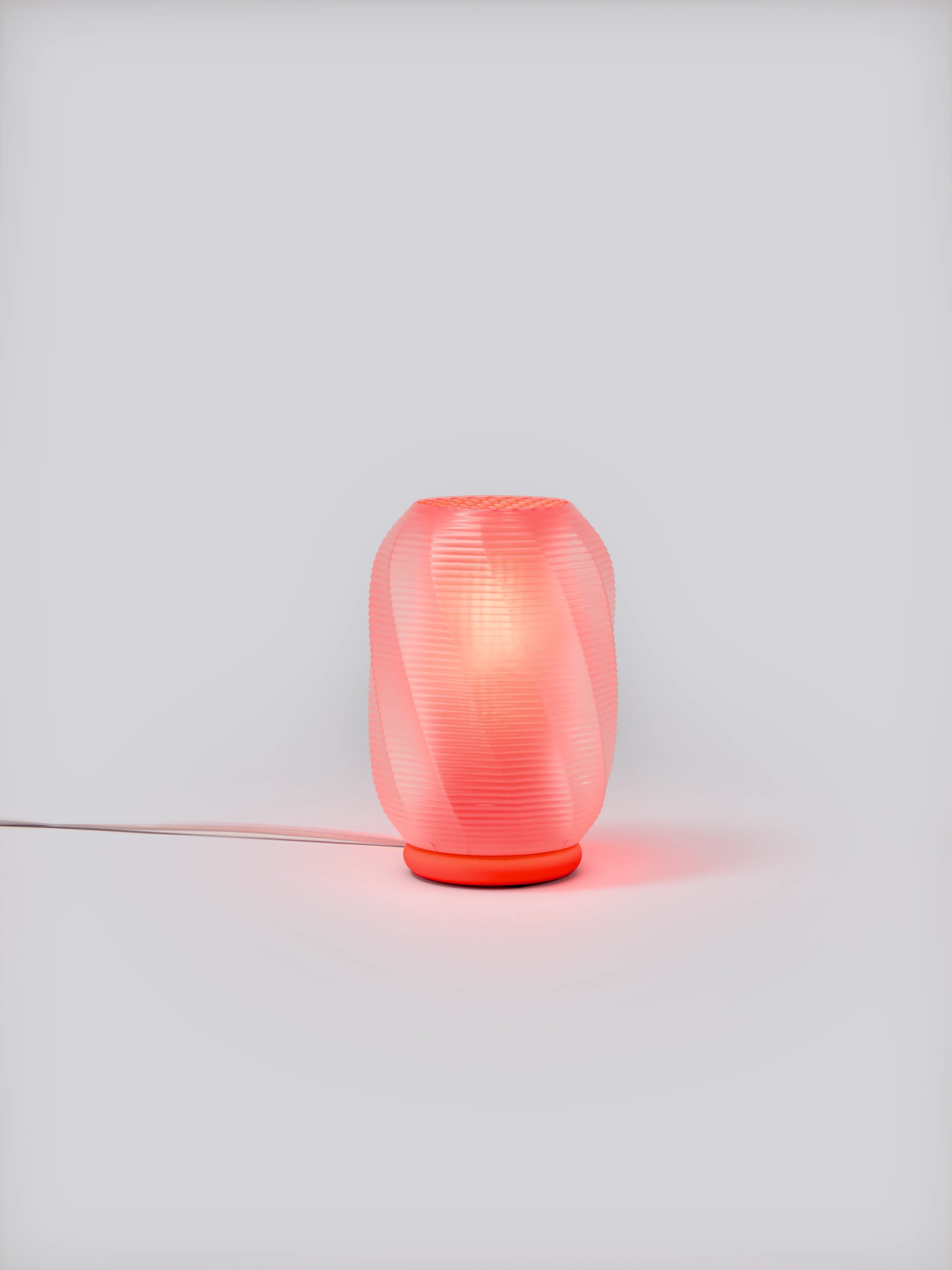 Red Nixie Lamp illuminated on a white studio background, showing colorful glow