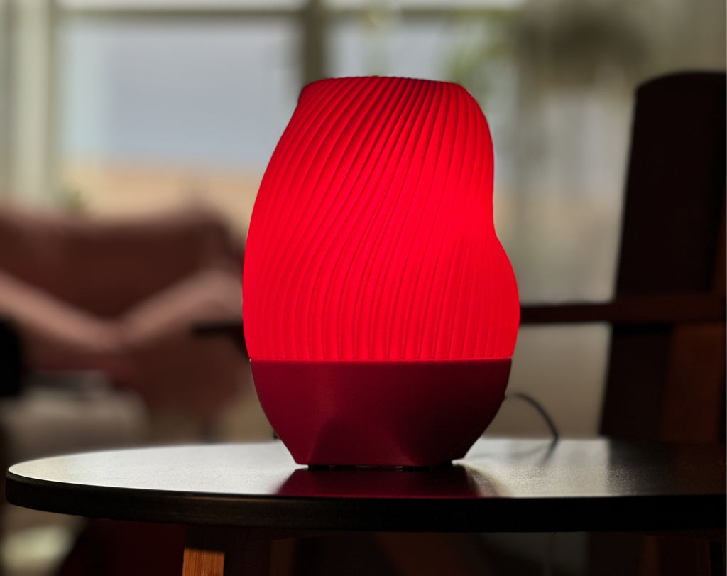 Pink Tama Lamp illuminated on a table