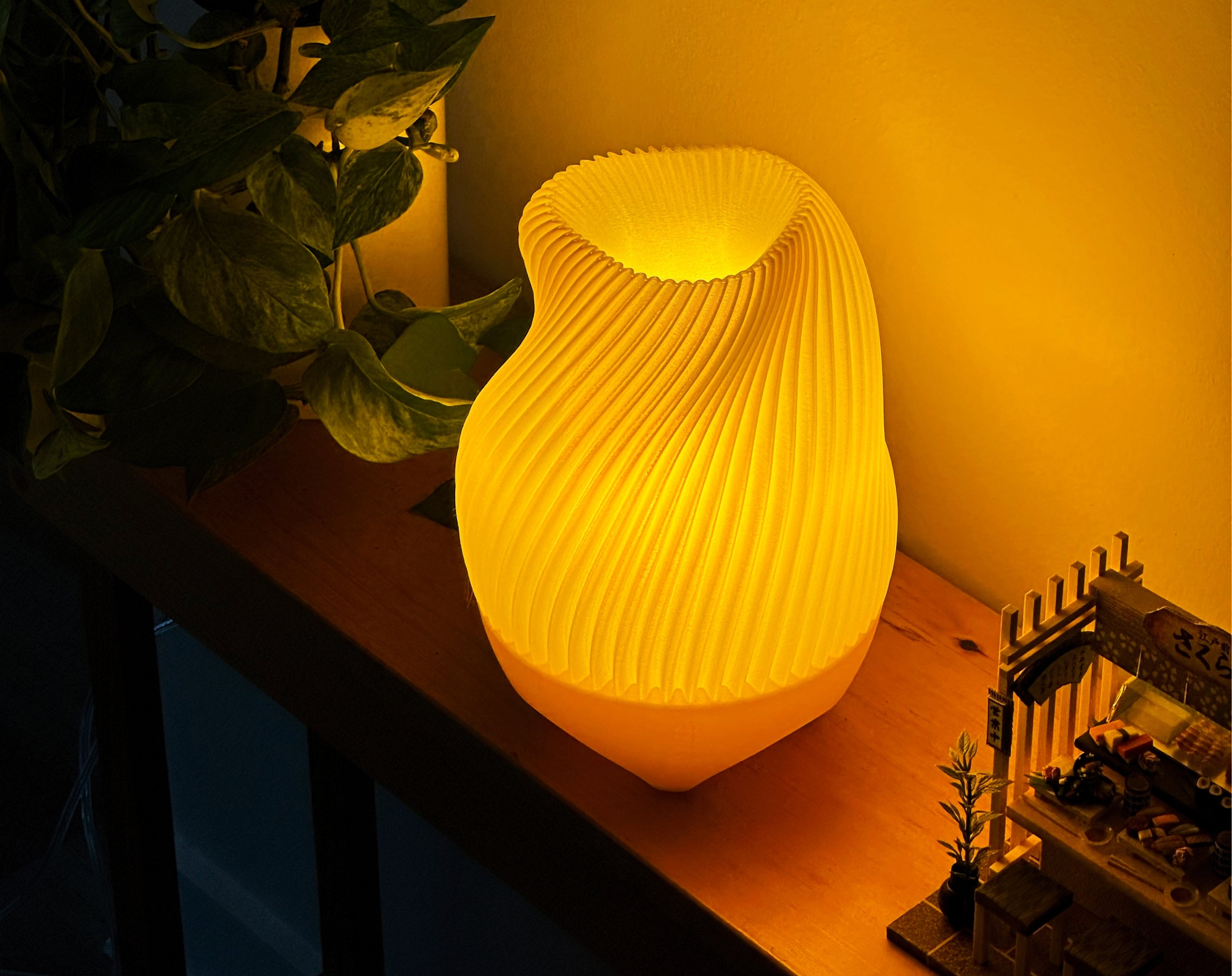 Yellow Tama Lamp illuminated on a table, styled with a sushi diorama