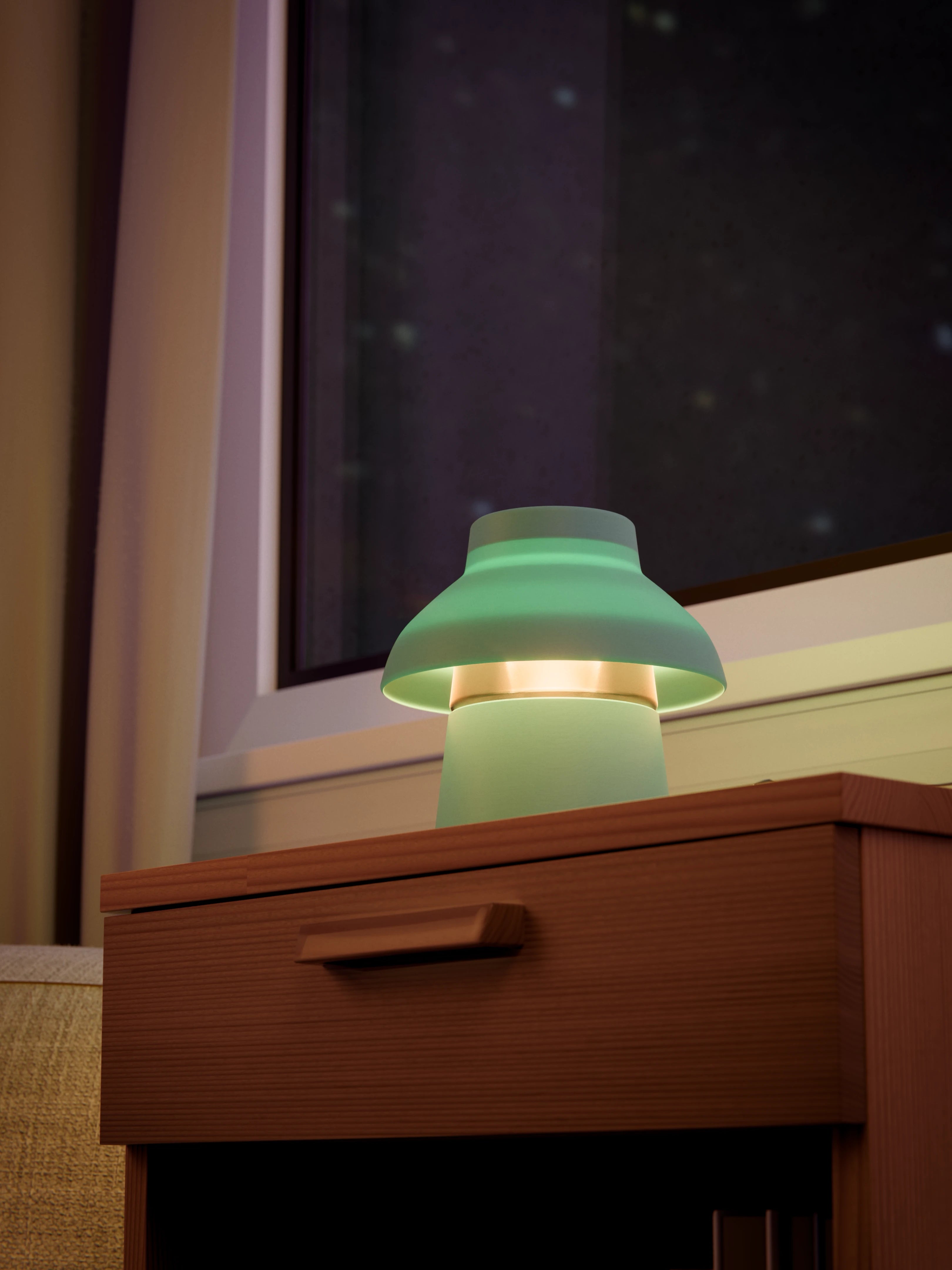 Light blue Zen Lamp illuminated on a living room side table, viewed from below.