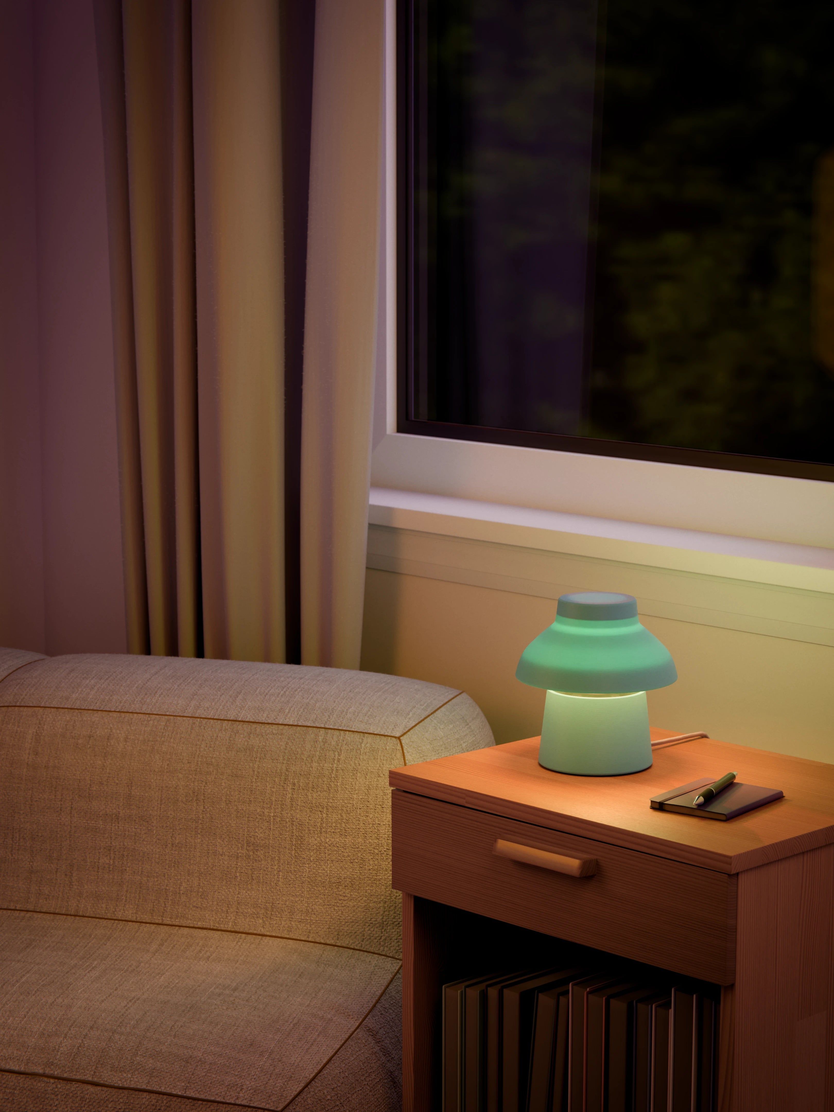 Light blue Zen Lamp illuminated on a living room side table with a pen an notebook.